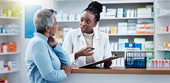 Woman talking to a pharmacist.