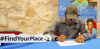 Young man signing paperwork.