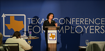 Woman giving a keynote presentation at a previous Texas Conference for Employers event.